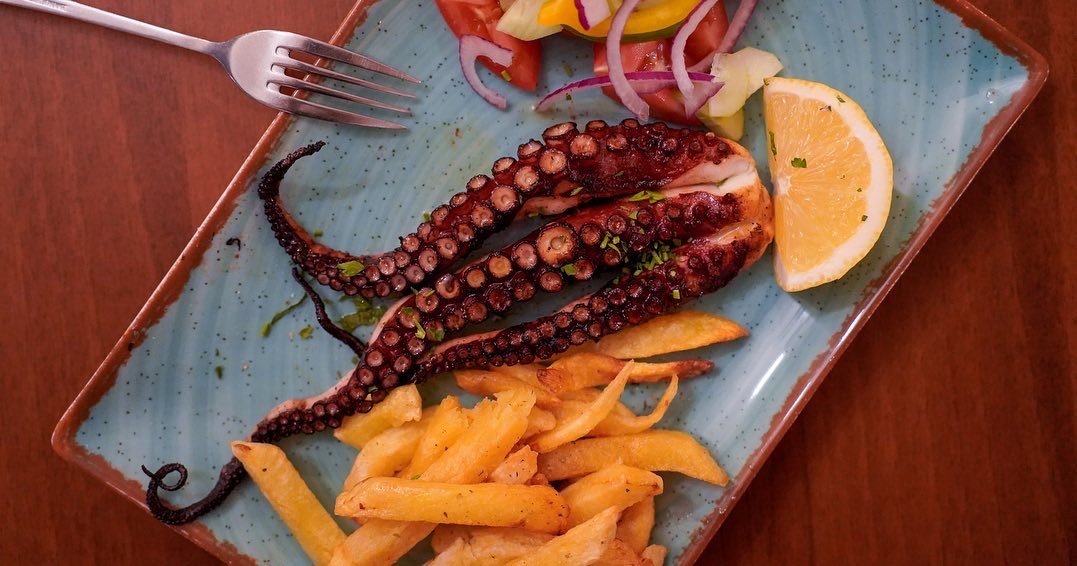 Grilled octopus served with traditional side