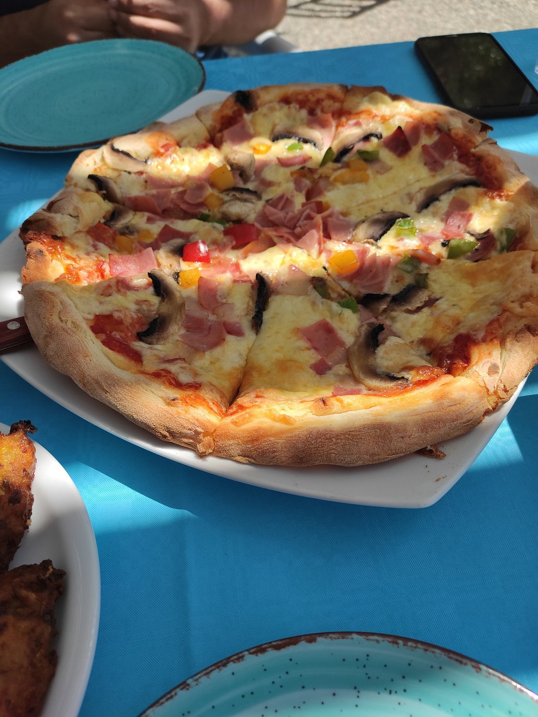 Special pizza with ham, peppers, mushrooms and bacon