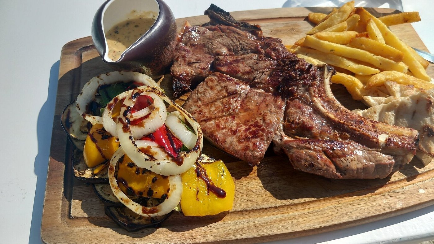 Steak served with fries and vegetables
